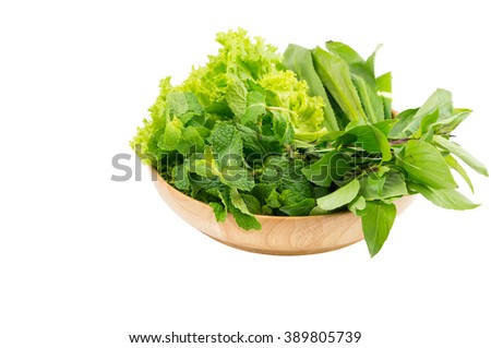 Green vegetables in wooden plate  on white isolated background. Selective focus. Royalty-Free Stock Photo #389805739