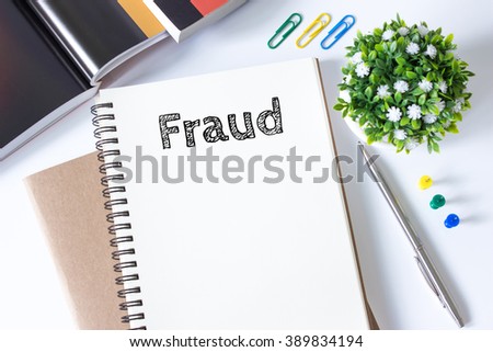 fraud word message on white paper book and copy space on white desk / business concept / top view