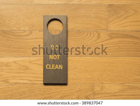 sign a pointer to the board on wood floor background.
