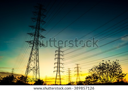Silhouette High voltage  electricity pylon system on sunrise background