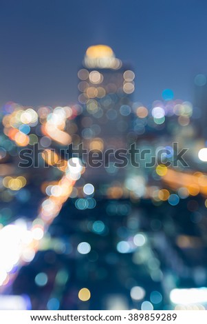 Night blurred bokeh lights, office building aerial view