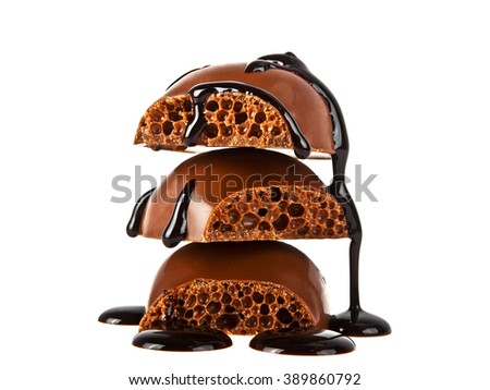 Pieces of tile porous milk chocolate poured chocolate isolated on white background