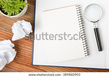 Office desk table with supplies and crumled paper. Top view. Copy space for text