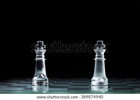 Confrontation - two chess king standing against each other on a chessboard.
