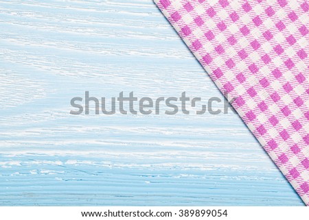 Purple textile, napkin, tablecloth on blue wooden kitchen table. View from above, top with copy space. Traditional pattern and color.
