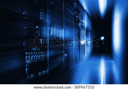 server room in the dark, with bright colored lights motion Royalty-Free Stock Photo #389967310