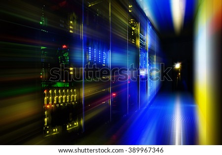 server room in dark, with bright colored lights motion Royalty-Free Stock Photo #389967346