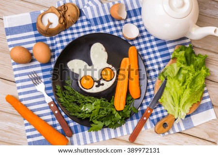Two fried eggs in the shape of an rabbit for healthy breakfast. Cheerful children's breakfast.