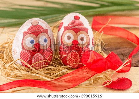 Couple of owl decoupage decorated Easter eggs