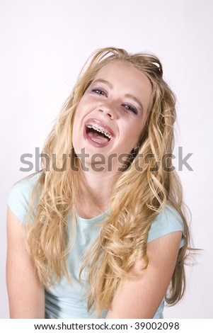 A teenage girl expressing her happy side by laughing.