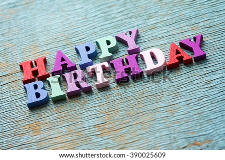Happy Birthday phrase made of wooden colorful letters on vintage background