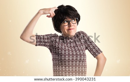 Girl with vintage look having doubts over ocher background