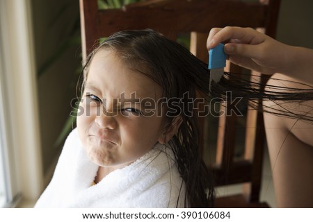 a girl is upset face, she got head lice from a school friend and do combing treatment