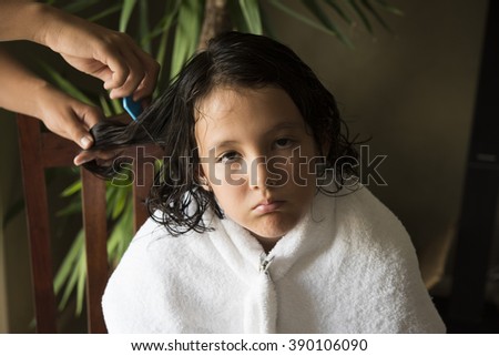 a girl is upset face, she got head lice from a school friend and do combing treatment