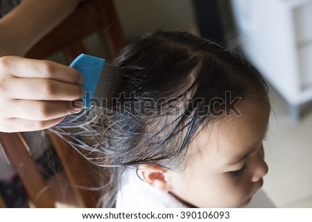 a girl is doing head lice treating. a closed up shot.