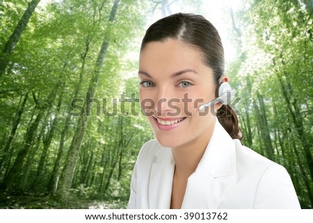 Beautiful headset operator woman in an ecological forest green background [Photo Illustration]