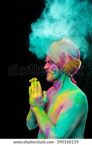 Senior man in traditional Indian turban fully covered with paint holi