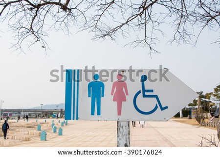 Sign of public toilets, men lady and  wheelchair in garden