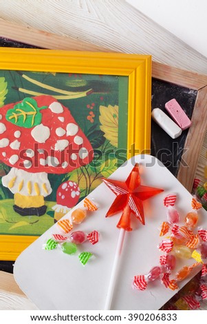 children's drawing plasticine mushroom amanita autumn still life on a table board crayons candy lollipop caramel idea crafts