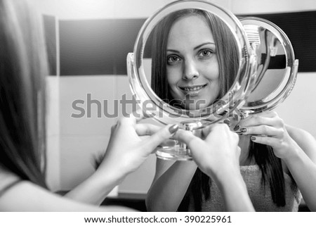 Portrait of a beautiful freckles woman in the mirror. Black and white.