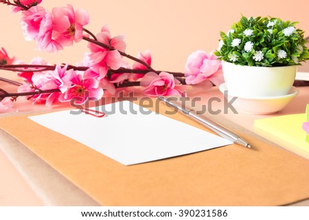 white paper blank, pen on light orange desk and office supplies / copy space and write space for write text or message  / business concept / top view