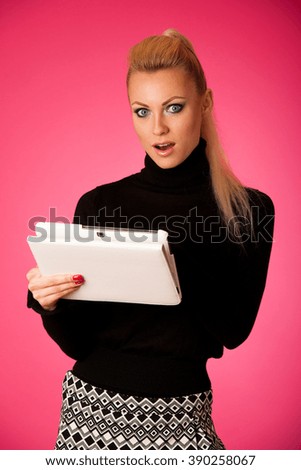 Bussiness woman using tablet computer, reading news shoced, scared, frustrated.