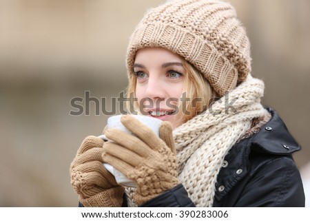 Beautiful girl enjoying a cup of tea outdoors