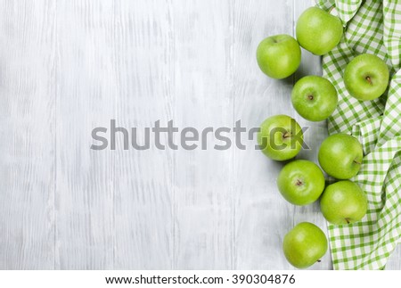 Green apples over wooden table. Top view with copy space