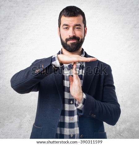 Handsome man making time out gesture