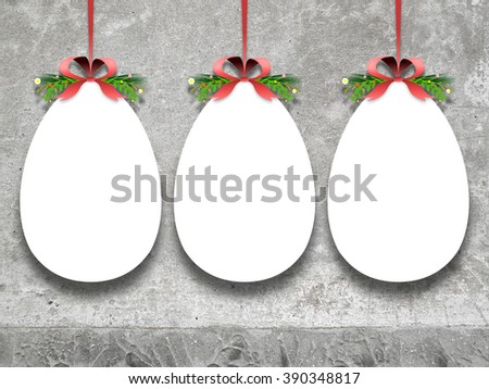 Close-up of three hanged blank decorated Easter eggs with ribbon against weathered concrete wall background