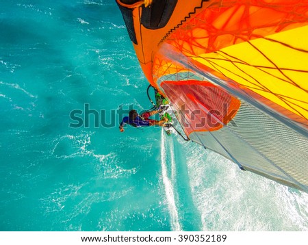 Top mounted camera photo of windsurfing riding on the on turquoise water