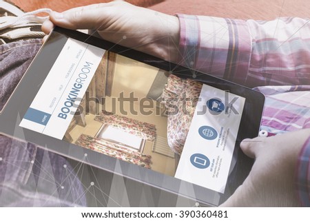 close-up view of man holding a tablet showing book online site. book online concept. All screen graphics are made up.
