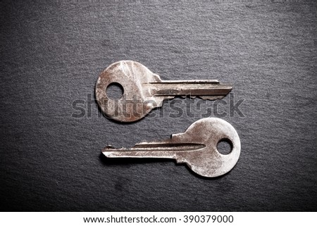 Old metal keys on black background. Top view. Toned.