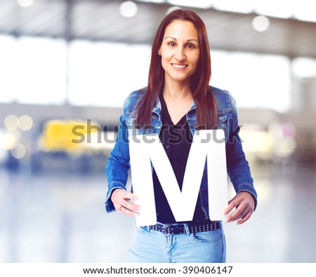 woman holding the M letter