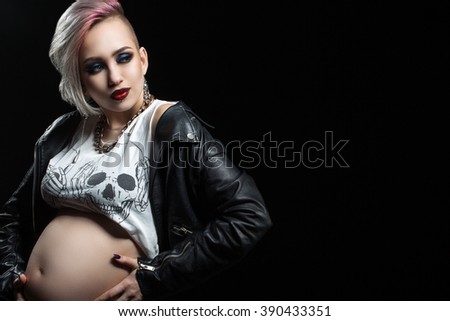 Young and eccentric woman on a black background, pregnancy decorate any woman