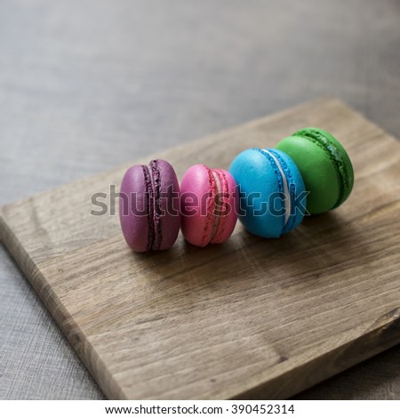 Colorful macaroons on wooden background, close up