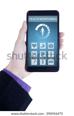 Close up of hand holding a smartphone with health monitoring application on the screen