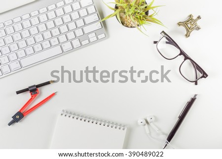 School office supplies,Mix of office supplies and gadgets working on a wooden desk,  with Notebooks, pens, keyboards,glasses, compasses,flowerpot,copy space can be used to put some text or images
