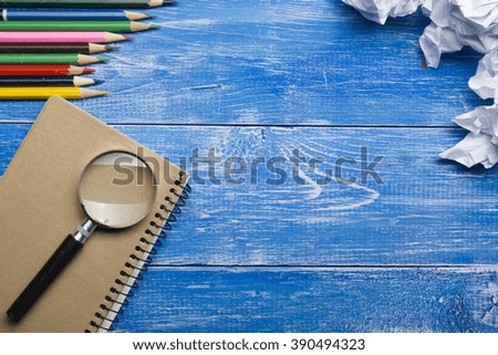 Office desk table with supplies and crumled paper. Top view. Copy space for text