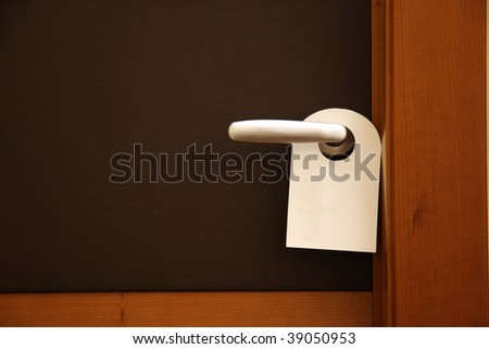 do not disturb sign on brown hotel door