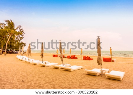 Beautiful tropical beach and sea landscape with umbrella and chair - Vintage Pastel Filter