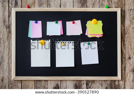 Abstract empty Blank chalkboard magnet with paper note and sticker note in wooden frame isolated on wooden background. empty space for add text.