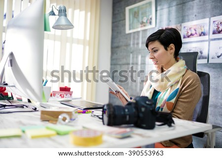 Young photographer and graphic designer at work in office