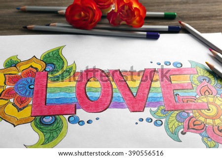 Bright picture with word LOVE, crayons and roses, close up