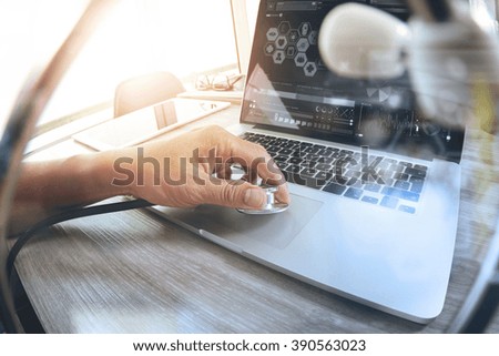 Medicine doctor hand working with modern laptop computer with stethoscope as medical network concept
