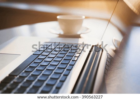 Place of work. Laptop and coffee on table in office or at home. Morning light. Business, technology, education online, work from home, education online, distance learning concept
