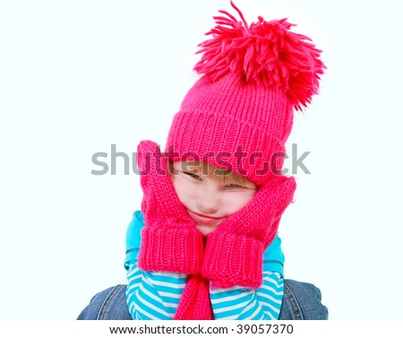 cute girl in bright hat making faces over white