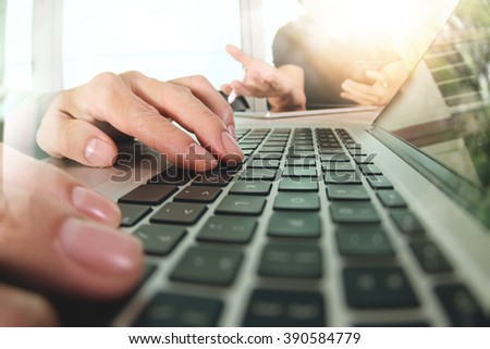 two colleagues Website designer working digital tablet and computer laptop with smart phone and digital design diagram on wooden desk as concept