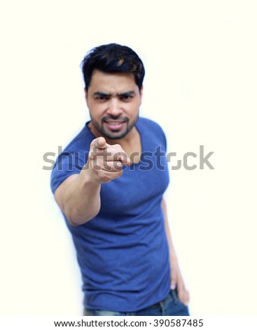 Young Indian man pointing the finger at you, isolated on white background