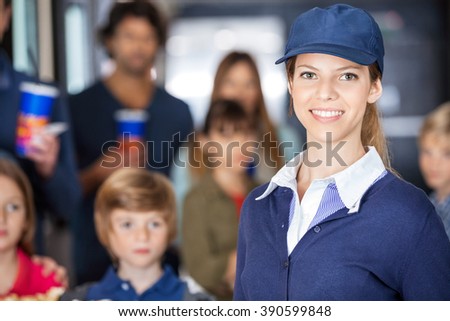 Beautiful Worker With Families In Background At Cinema